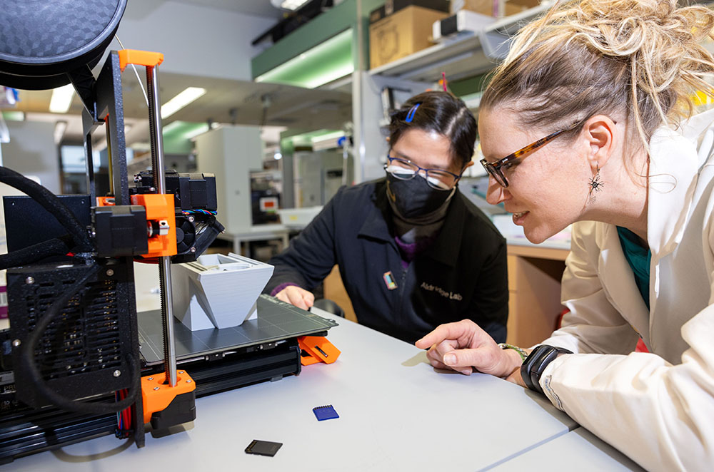 Iowa researcher Georgina Aldridge performs an experiment with a fellow colleague.